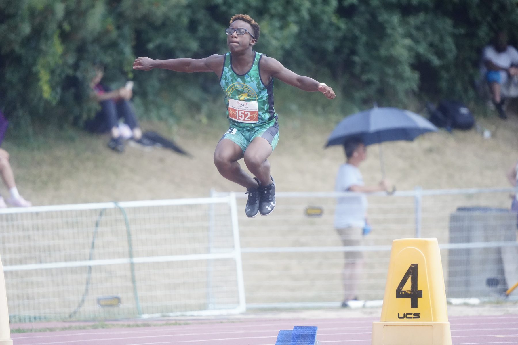 Long jumper soaring above the pit