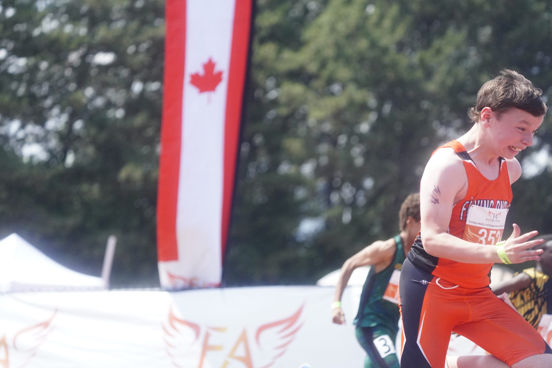 Athletes finishing with the Canadian flag flying