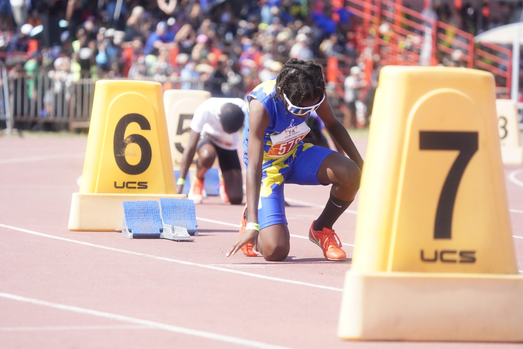 Full field of sprinters set in the blocks