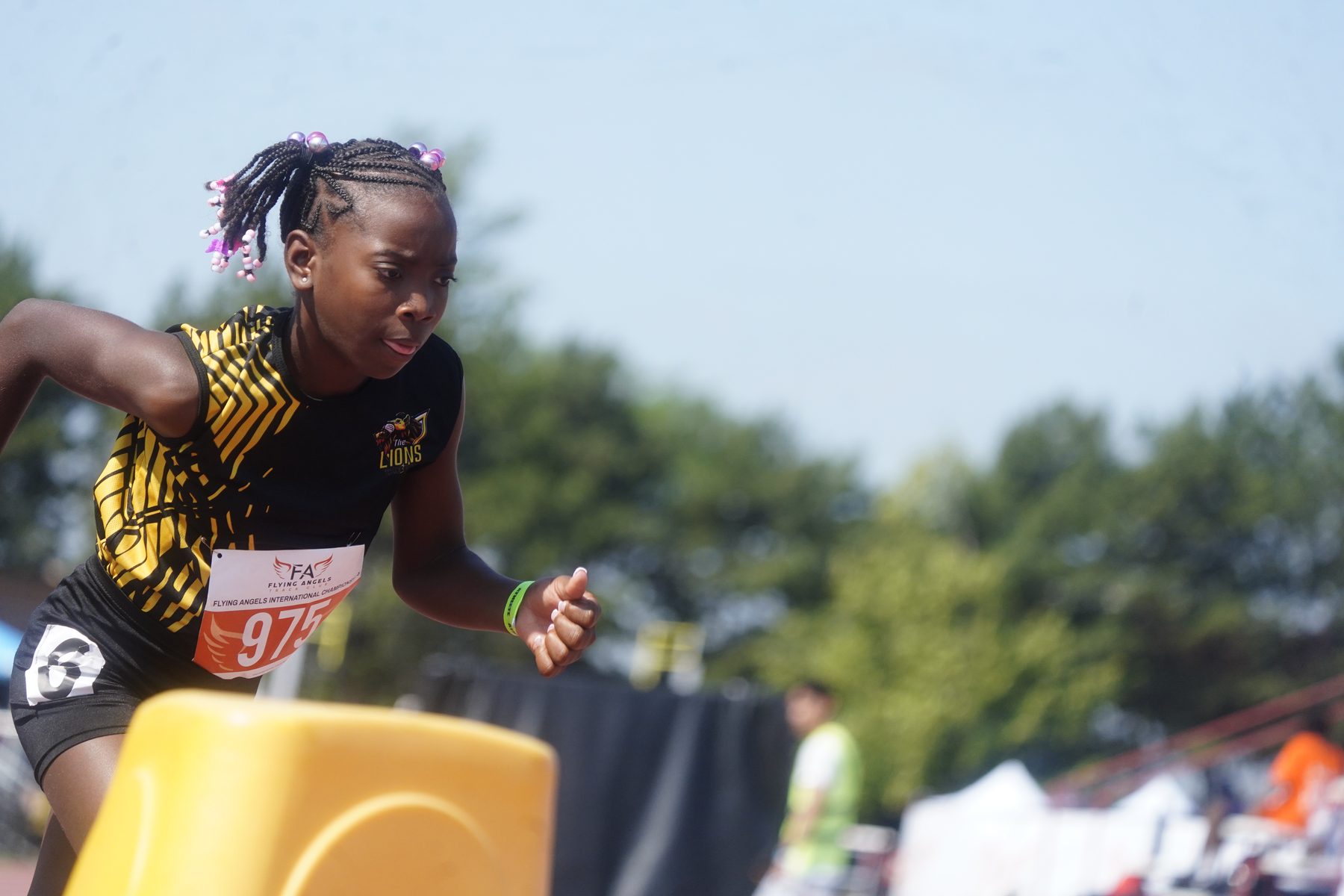 Young athlete airborne over a hurdle