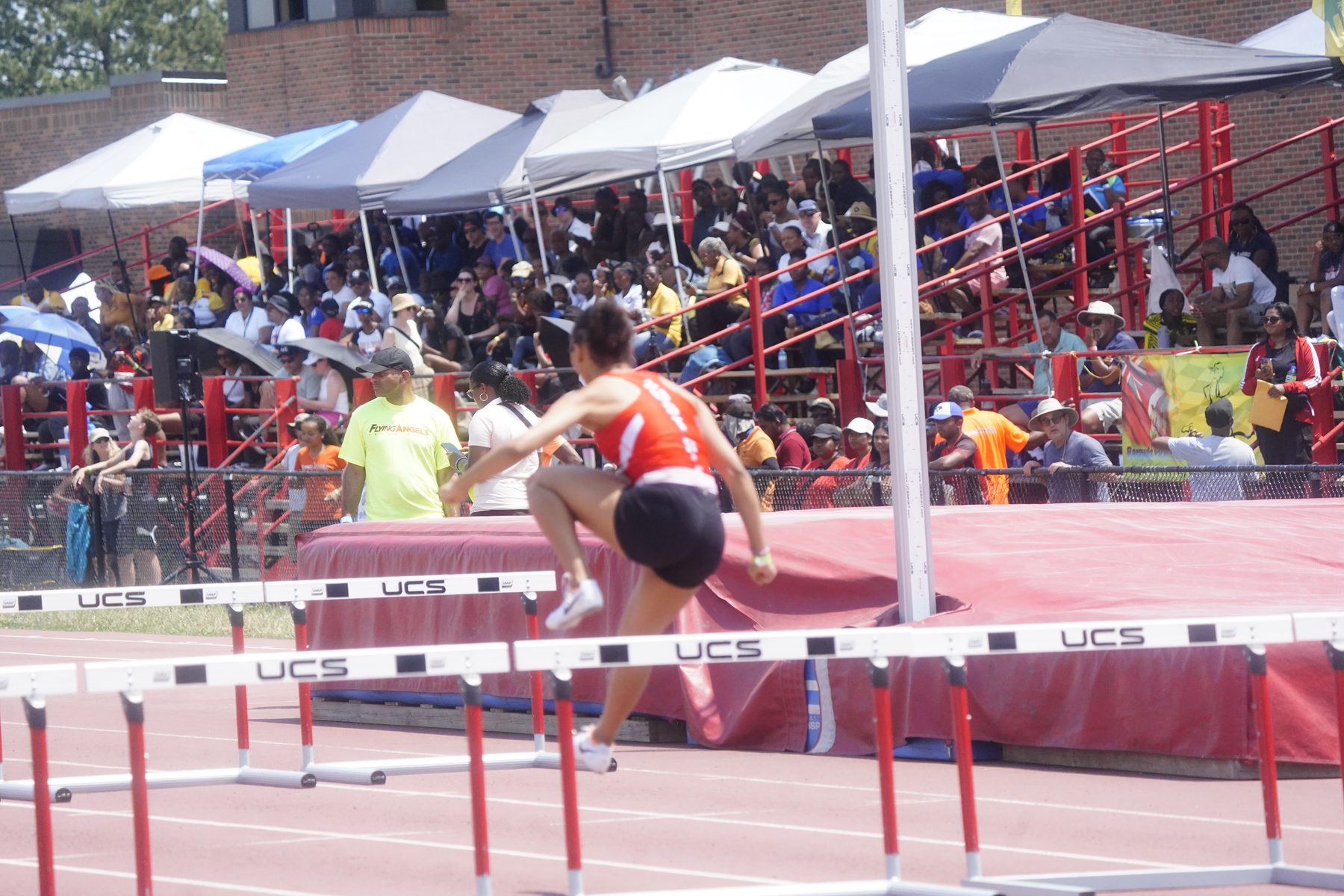 Athlete leaping a hurdle mid-stride